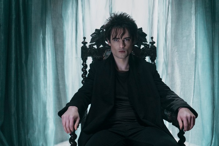 Tom Sturridge as Dream in The Sandman sitting in a chair.